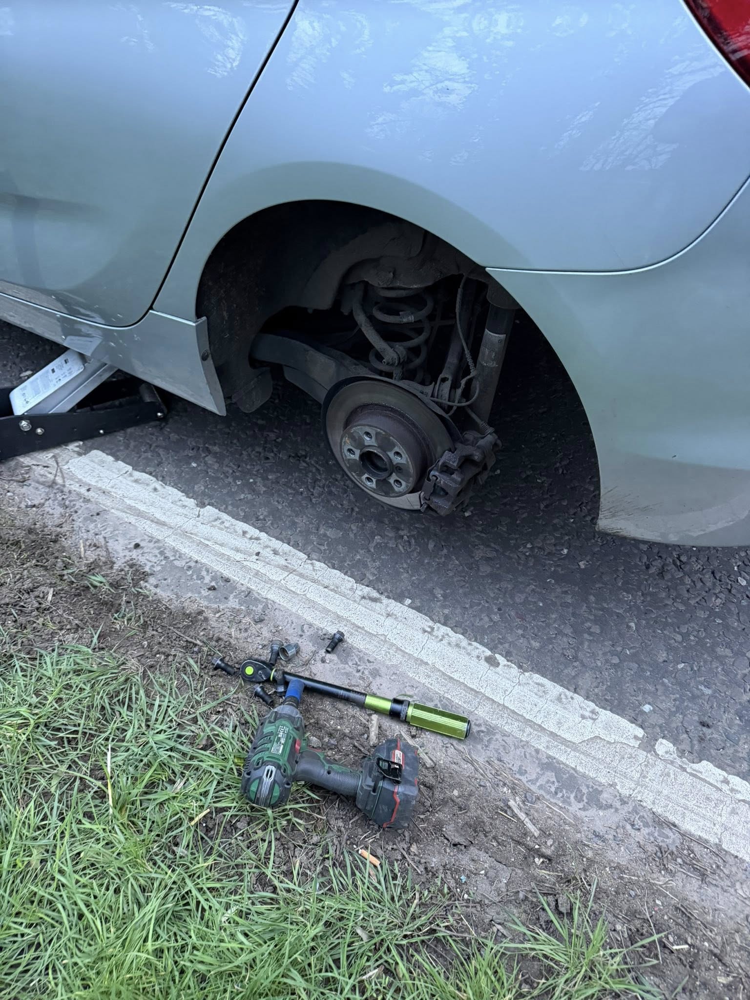 Roadside mobile tyre fitting with a wheel removed